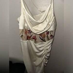 crème colored dress that has never been worn with a zipper on right side.